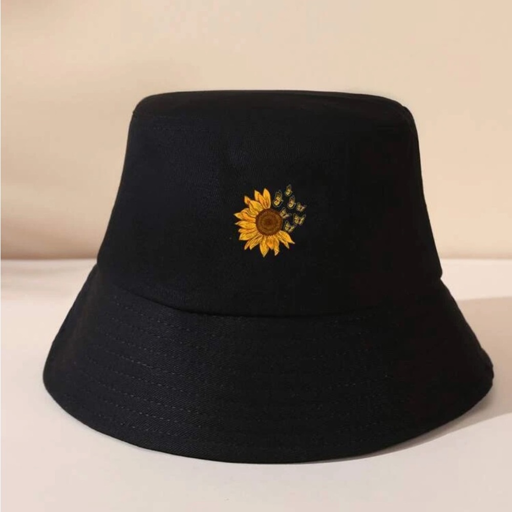 Black bucket hat with sunflower and butterfly embroidery.